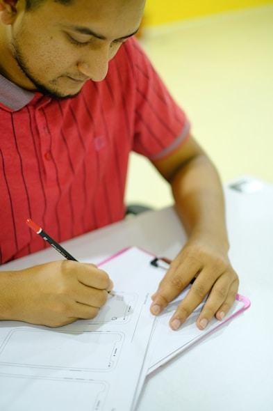 Designer sketching interface ideas in a notebook