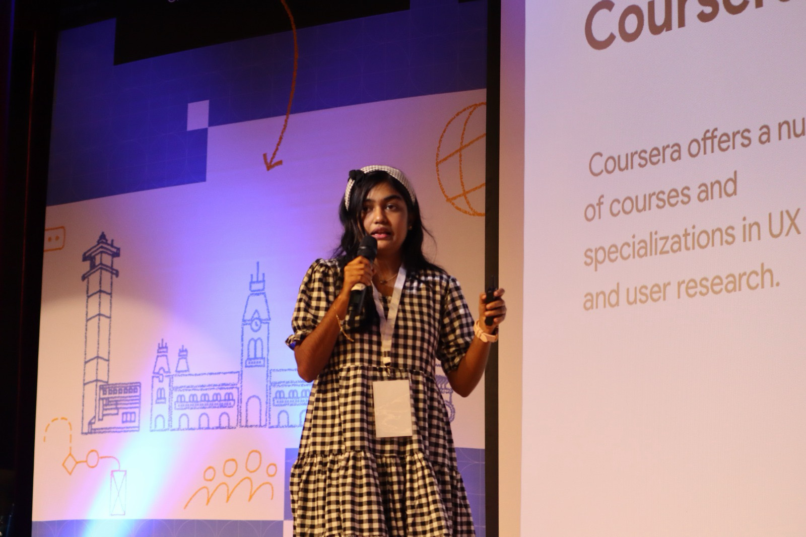 Instructor presenting UI/UX design concepts on stage during a live masterclass